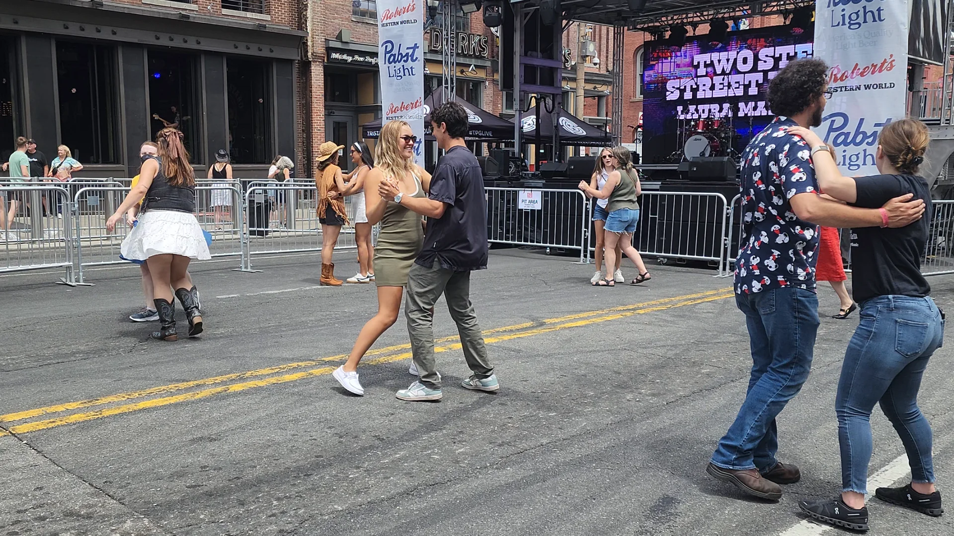 People dancing on Lower Broadway during the daytime.
